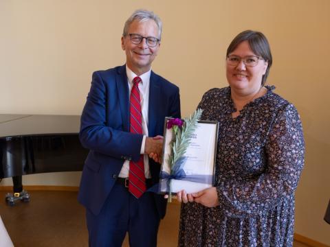 Hrönn Birgisdóttir tekur við viðurkenningu frá Jóni Atla Benediktssyni, rektor HÍ. 