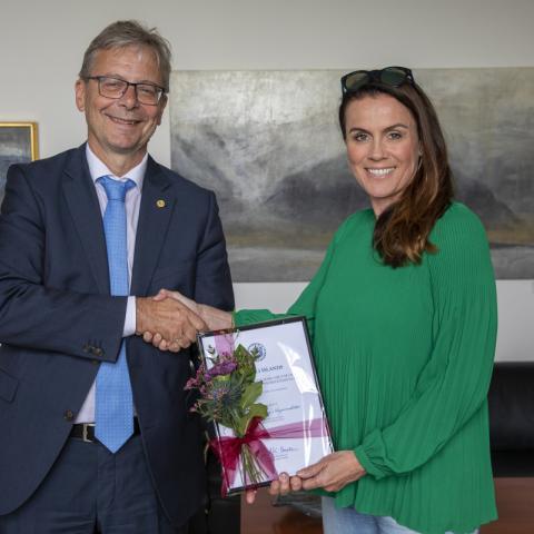 Tinna Laufey Ásgeirsdóttir, prófessor við Hagfræðideild, tekur við styrknum úr hendi Jóns Atla Benediktssonar, rektors Háskóla Íslands. 